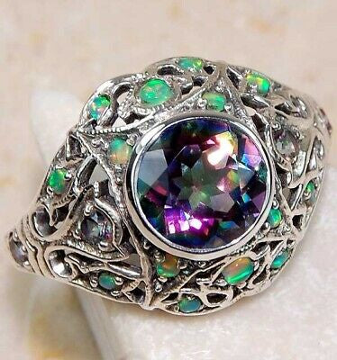 The promise 2 carat color changing rainbow topaz set in ornate sterling silver setting. Sz 8